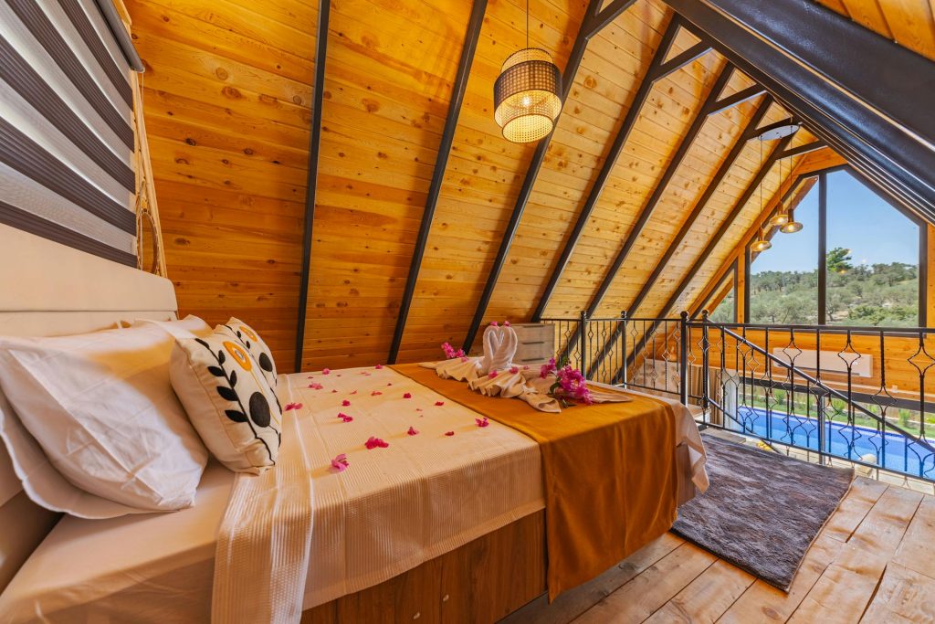 Attic Loft Bedroom in Wooden Cabin with Bed with Rose Petals Via pexels